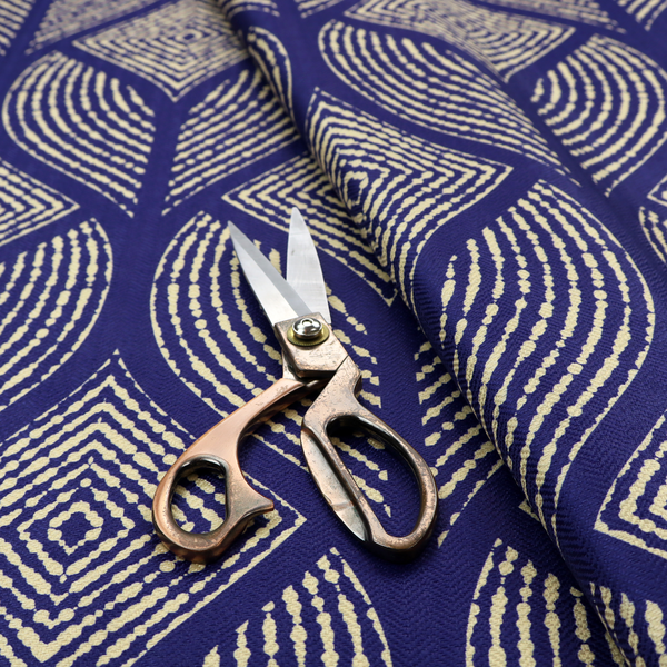 A geometric upholstery fabric featuring an elegant, symmetrical pattern of interlocking diamond shapes and stylized, dotted leaf arches in cream on a royal blue background.   
