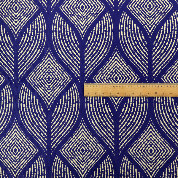 A geometric upholstery fabric featuring an elegant, symmetrical pattern of interlocking diamond shapes and stylized, dotted leaf arches in cream on a royal blue background.   
