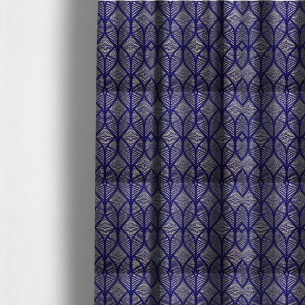 The fabric used to create these made-to-measure curtains is a geometric upholstery fabric featuring an elegant, symmetrical pattern of interlocking diamond shapes and stylized, dotted leaf arches in cream on a royal blue background.   
