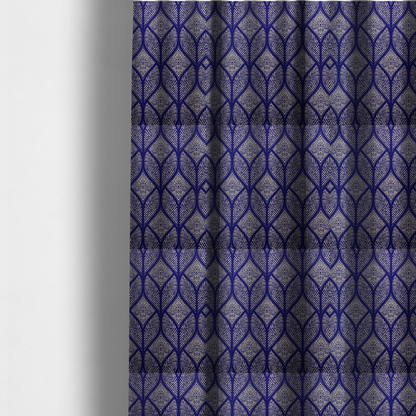 The fabric used to create these made-to-measure curtains is a geometric upholstery fabric featuring an elegant, symmetrical pattern of interlocking diamond shapes and stylized, dotted leaf arches in cream on a royal blue background.   
