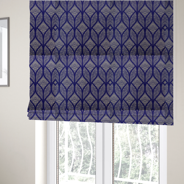 The fabric used to create these Roman blinds is a geometric upholstery fabric featuring an elegant, symmetrical pattern of interlocking diamond shapes and stylized, dotted leaf arches in cream on a royal blue background.   
