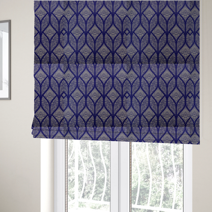 The fabric used to create these Roman blinds is a geometric upholstery fabric featuring an elegant, symmetrical pattern of interlocking diamond shapes and stylized, dotted leaf arches in cream on a royal blue background.   
