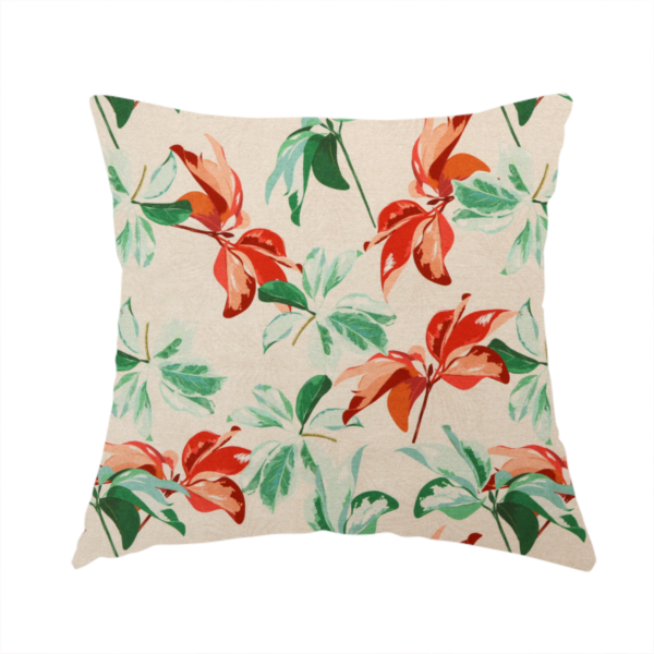 The fabric used to create this handmade cushion is a botanical upholstery fabric on a neutral cream background featuring a repeating painterly pattern of leafy branches in shades of vibrant orange, coral, deep green, and pale mint-green.   
