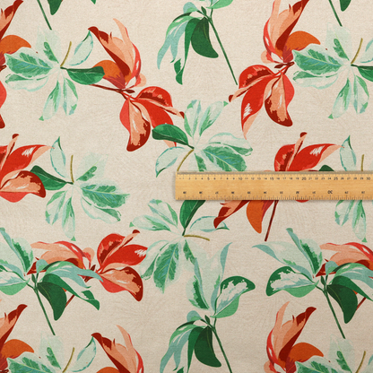 A botanical upholstery fabric on a neutral cream background featuring a repeating painterly pattern of leafy branches in shades of vibrant orange, coral, deep green, and pale mint-green.   